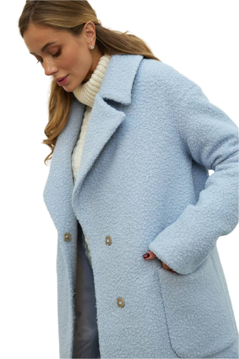 Woman wearing a light blue coat on a white background