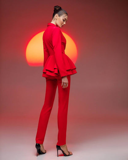 Woman in a red outfit with a sun-like object in the background