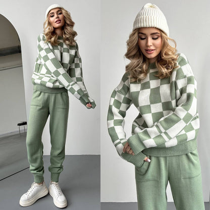Woman wearing a green and white checkered sweater and pants set with a white beanie.