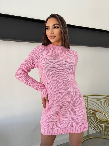 Woman wearing a pink knitted dress against a neutral background