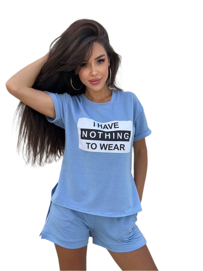 Woman wearing a blue t-shirt with 'I HAVE NOTHING TO WEAR' text and matching shorts on a white background