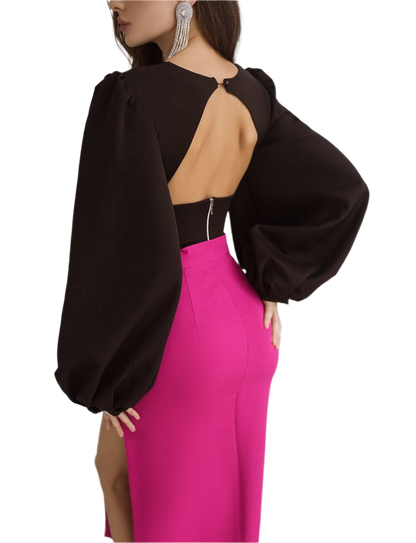 Black top with open back and pink skirt on a white background