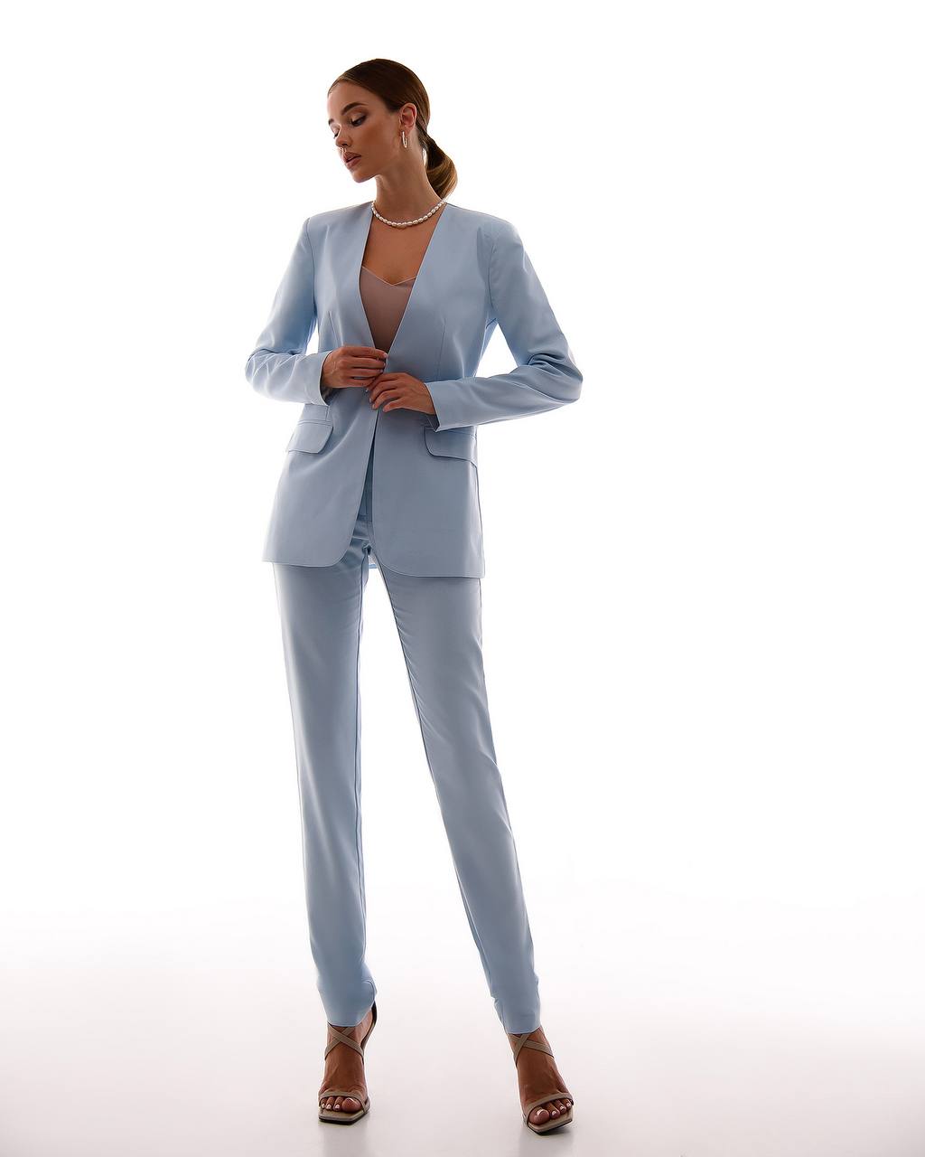 Woman wearing a light blue suit on a white background