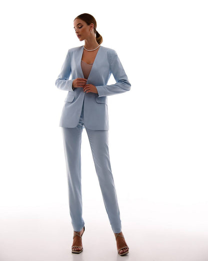 Woman wearing a light blue suit on a white background