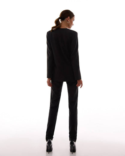Person wearing a black suit on a white background