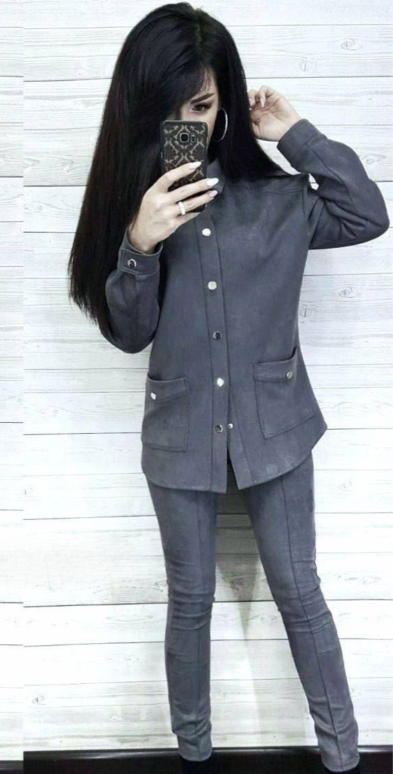 Person wearing a gray outfit with a white background