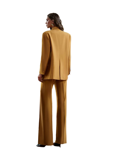 Woman wearing a mustard yellow suit on a white background