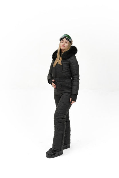 Person wearing a black puffer suit with fur hood on a white background