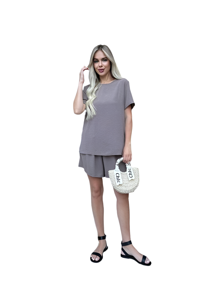 Woman wearing a gray outfit with a white background