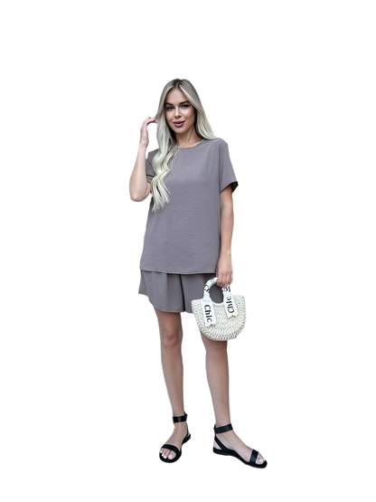 Woman wearing a gray outfit with a white background