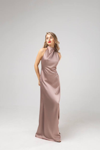 Woman wearing a long, elegant dress on a white background