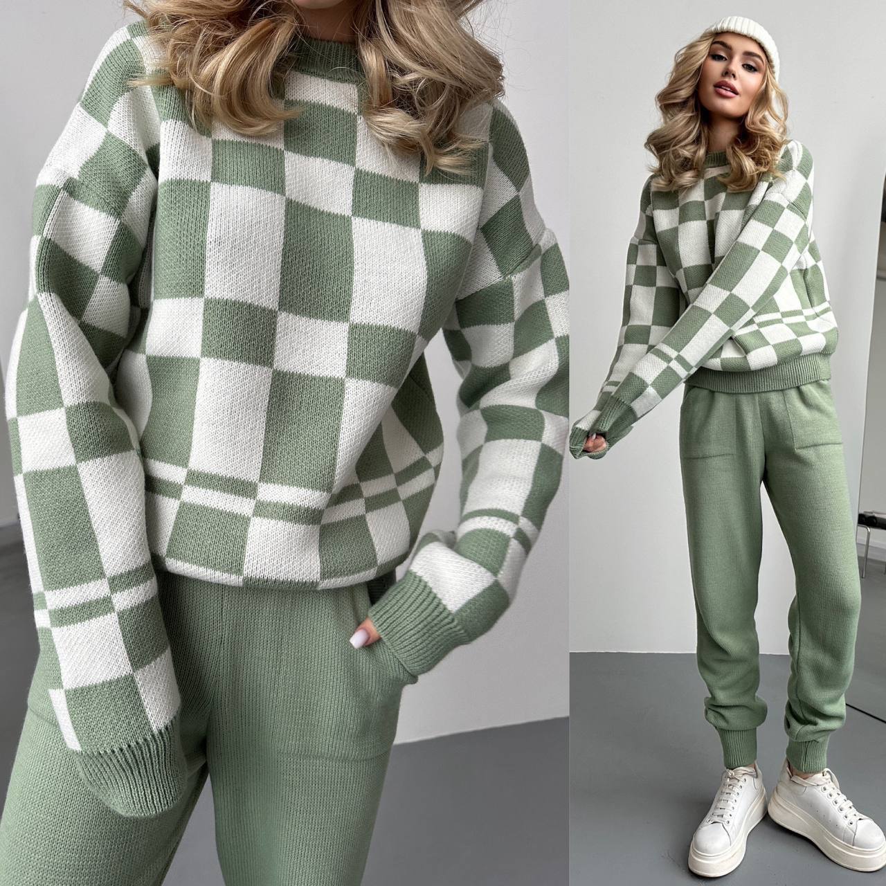Green and white checkered sweater and pants worn by a person on a plain background
