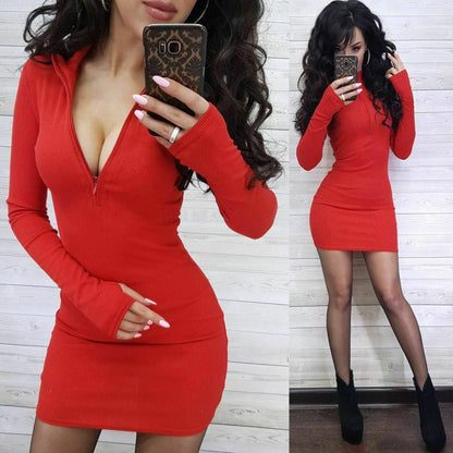 Woman wearing a red dress with long sleeves, taking a mirror selfie.