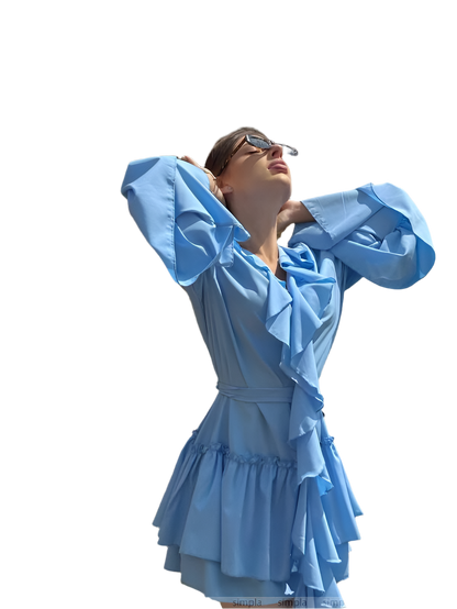 Woman wearing a light blue dress with ruffled sleeves and skirt on a white background