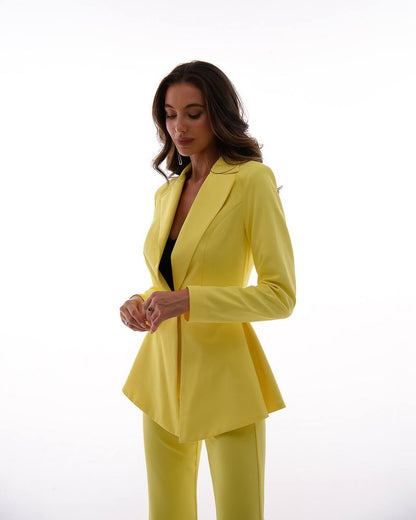 Woman wearing a bright yellow suit on a white background