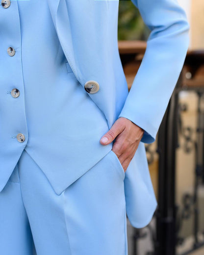Light blue suit with buttons on a blurred background