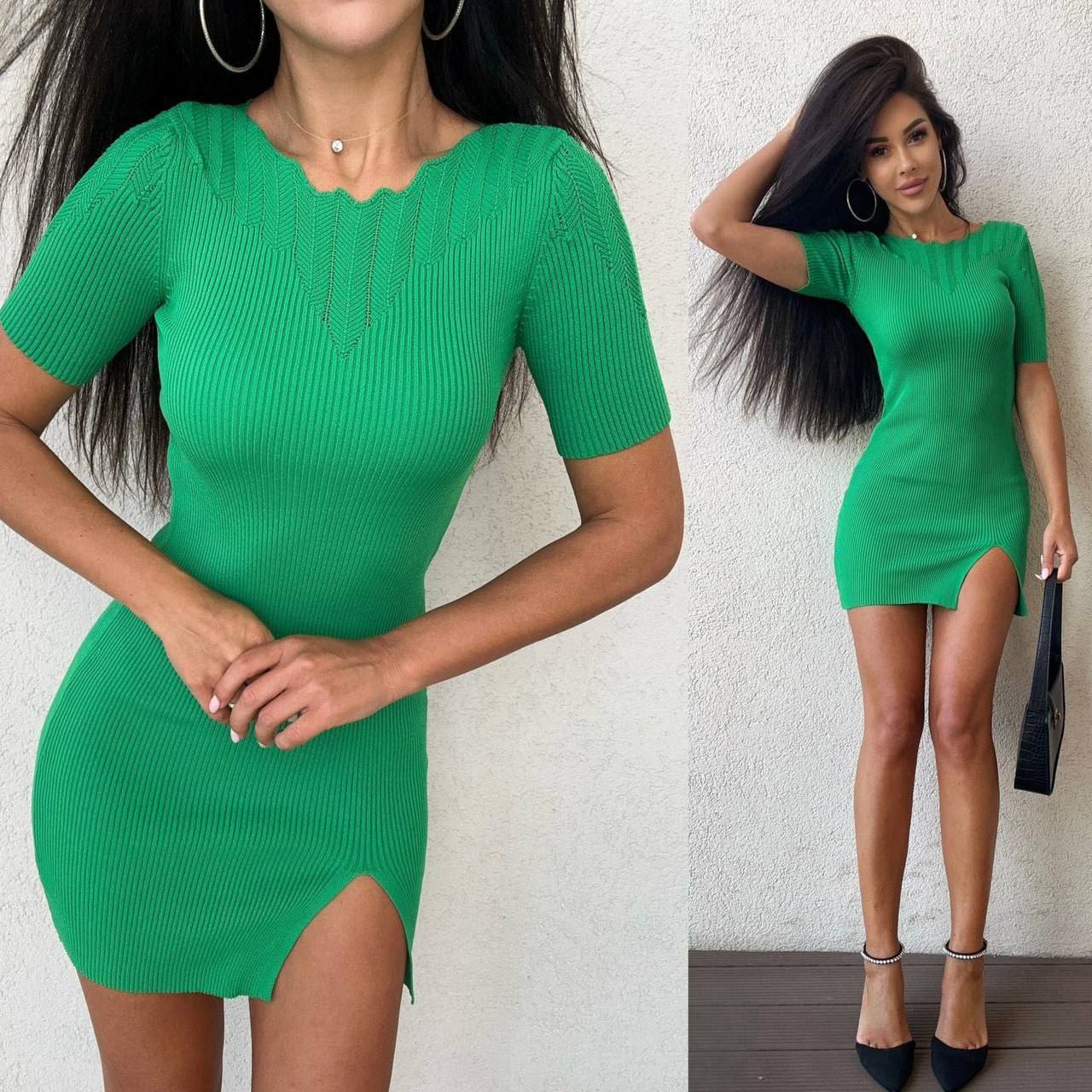 Green dress with a front slit worn by a model against a white background