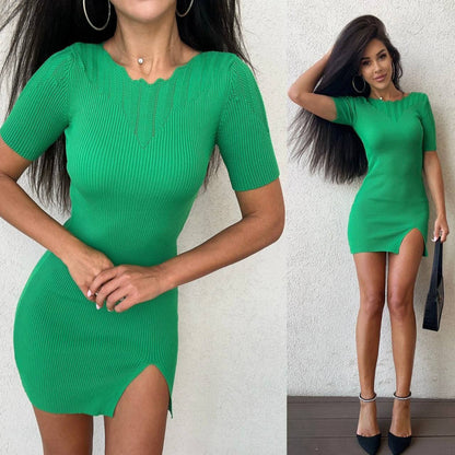 Green dress with a front slit worn by a model against a white background