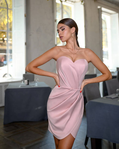 Woman wearing a pink strapless dress in an indoor setting