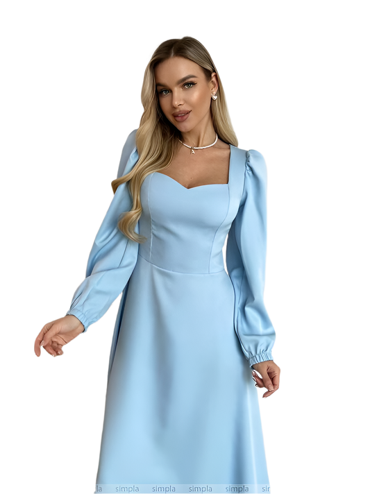 Woman wearing a light blue dress with long sleeves on a white background