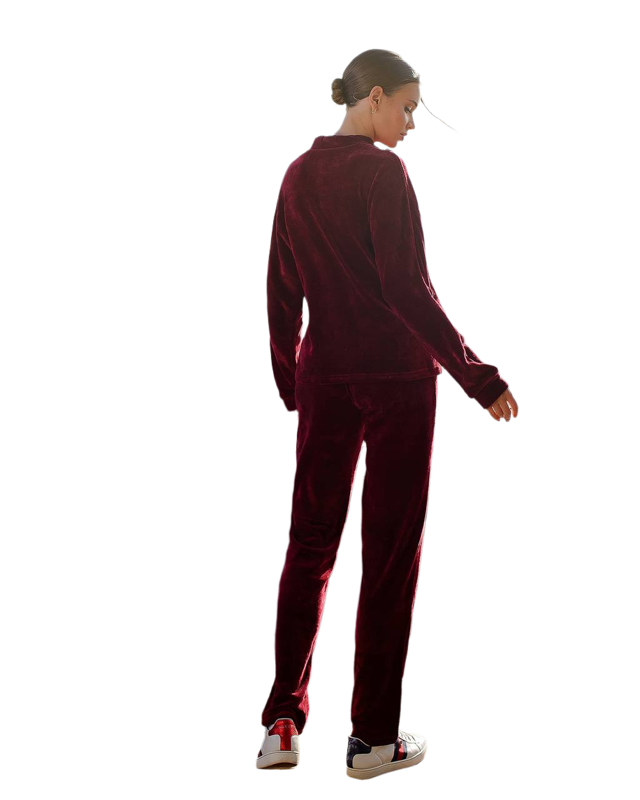 Person wearing a burgundy tracksuit on a white background