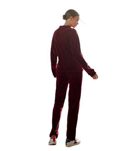 Person wearing a burgundy tracksuit on a white background