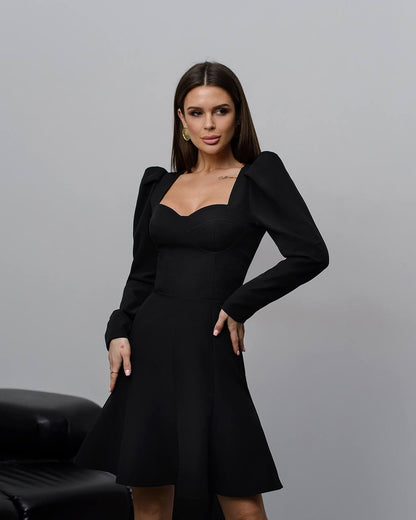 Woman wearing a black dress with a gray background