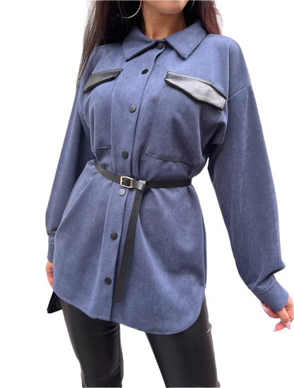 Blue shirt with black accents worn by a person on a white background