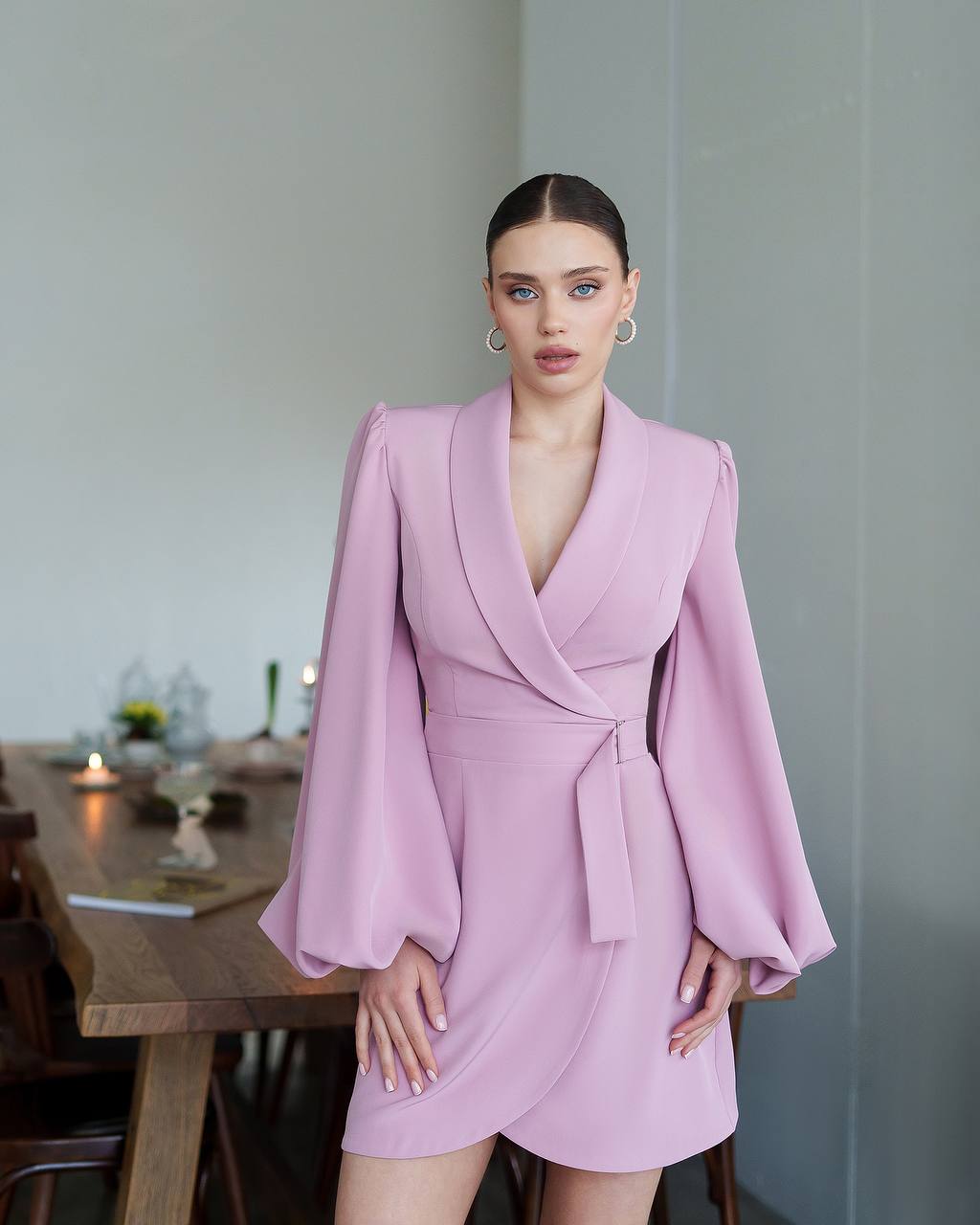 Woman wearing a pink dress in an indoor setting