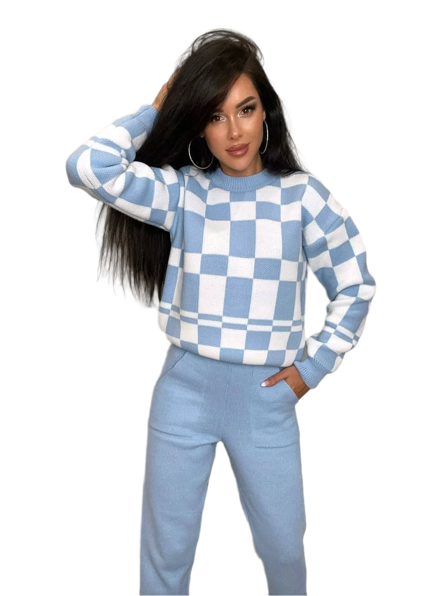 Woman wearing a blue and white checkered sweater and pants on a white background