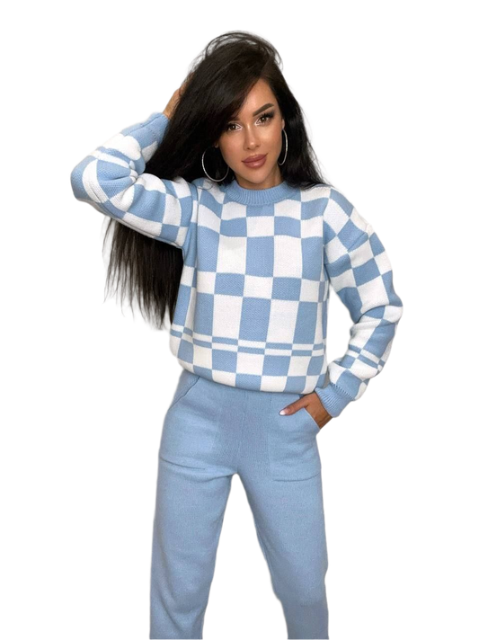 Woman wearing a blue and white checkered sweater and pants on a white background