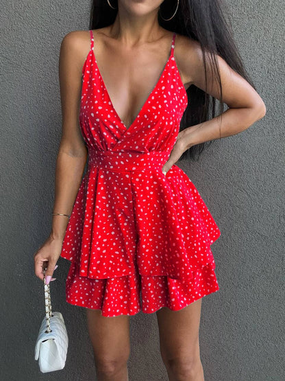 Red polka dot dress worn by a person against a gray background