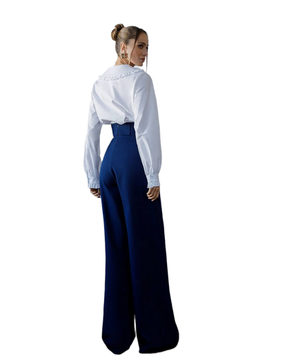 Person wearing a white blouse and blue high-waisted pants on a white background