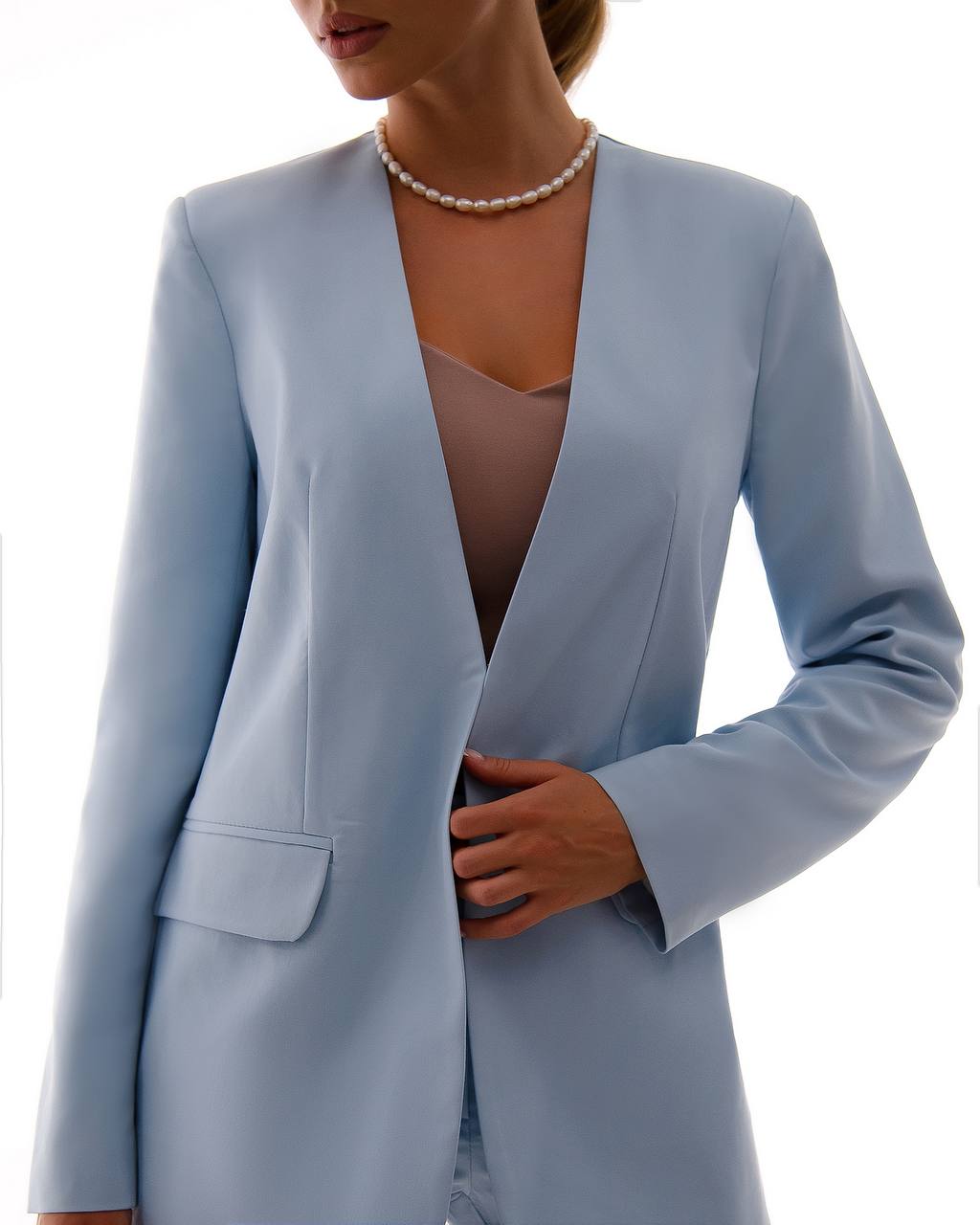 Light blue blazer worn by a person on a white background