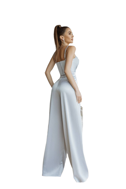Woman wearing a white jumpsuit on a white background
