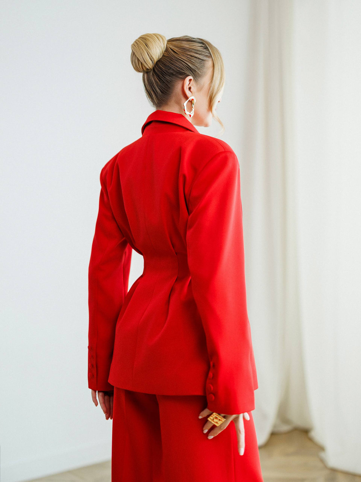 Person wearing a red outfit with a white background