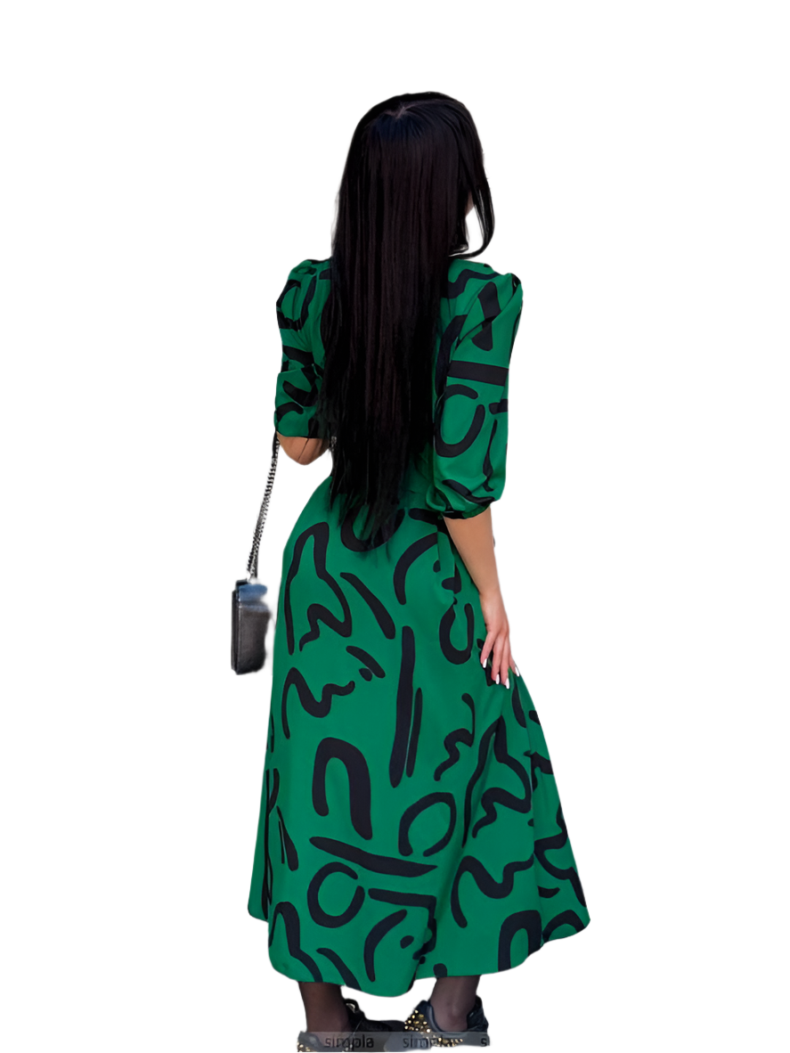 Woman wearing a green dress with black patterns on a white background