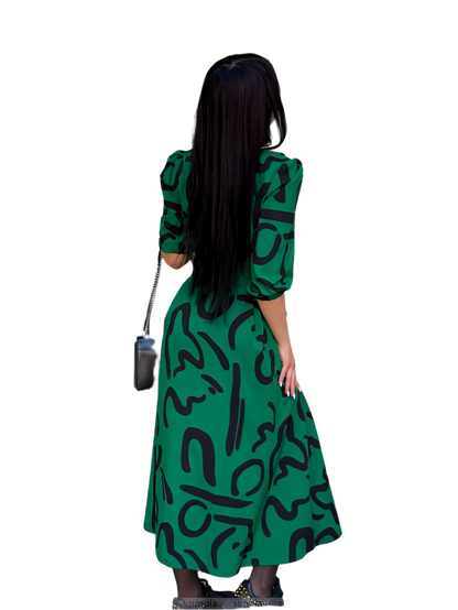 Woman wearing a green dress with black patterns on a white background