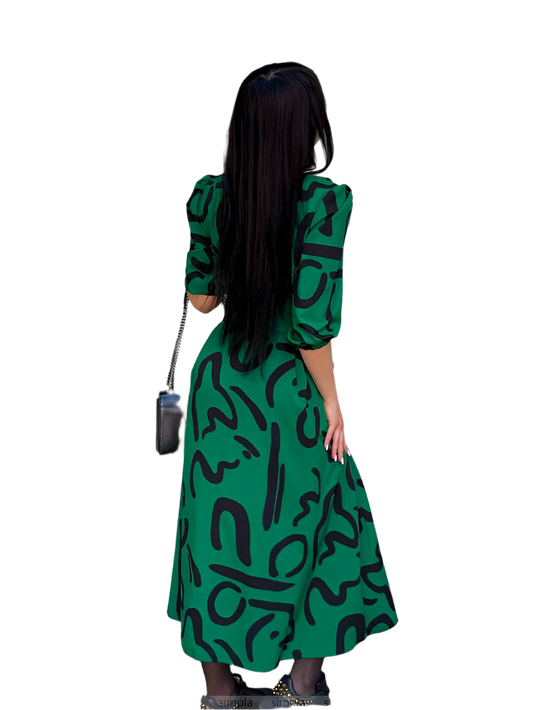 Woman wearing a green dress with black patterns on a white background