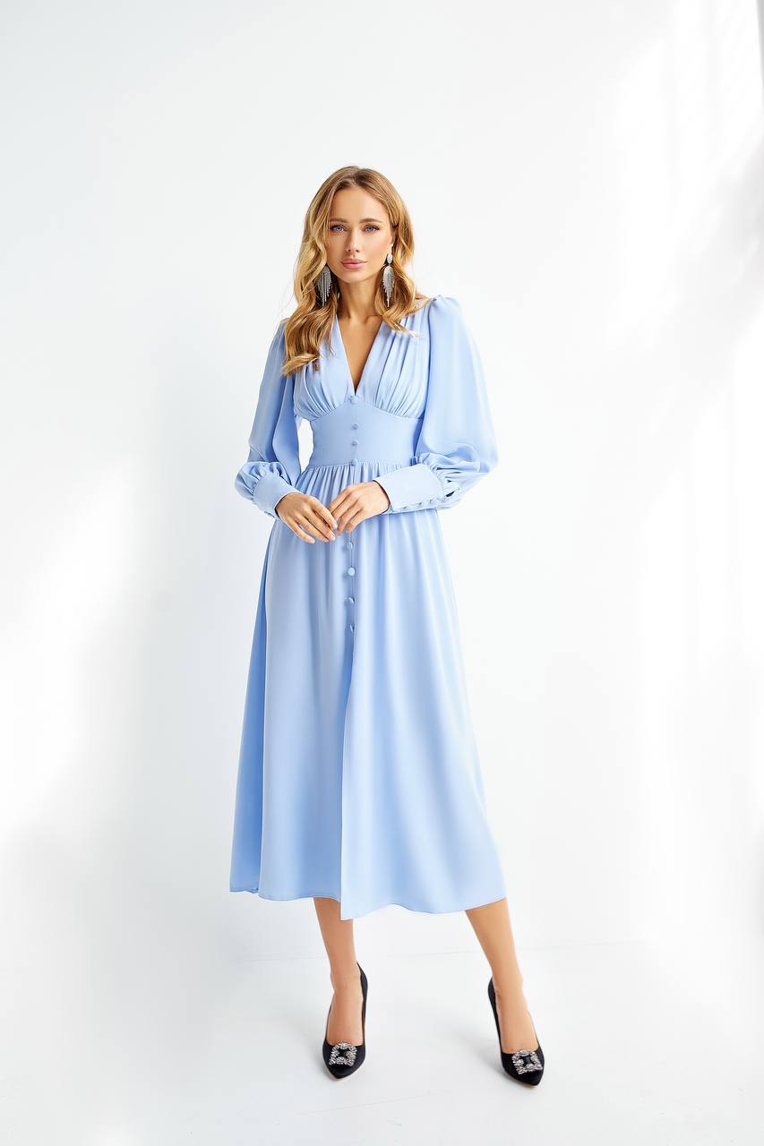 Woman wearing a light blue dress on a white background