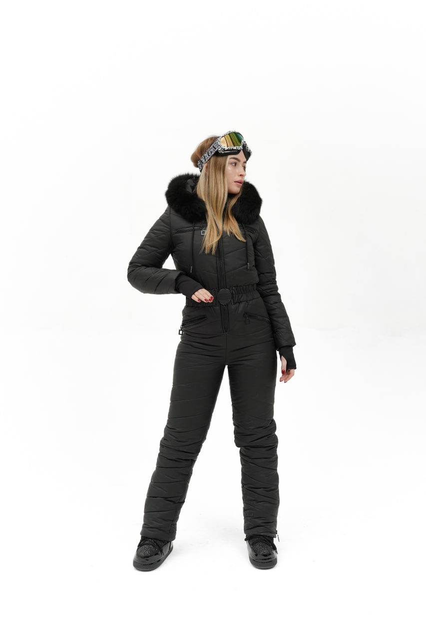 Person wearing a black winter suit with a hood on a white background