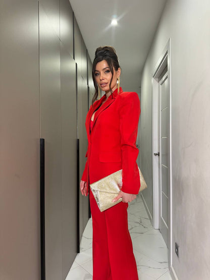 Woman in a red suit standing in a hallway