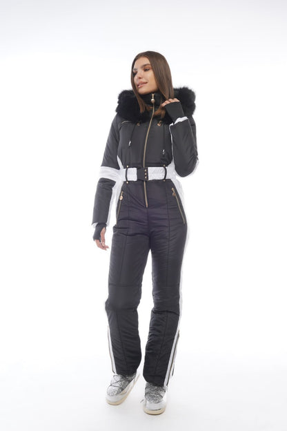 Person wearing a dark gray snowsuit with white accents on a white background