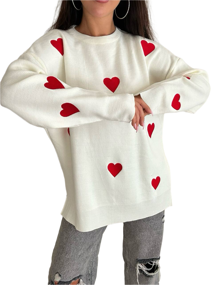 White sweater with red heart patterns worn by a person on a white background