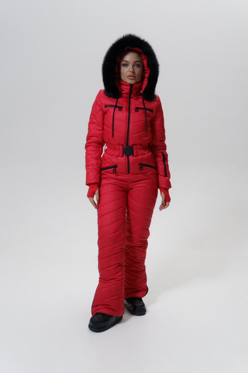 Person wearing a red winter suit with black fur hood on a white background