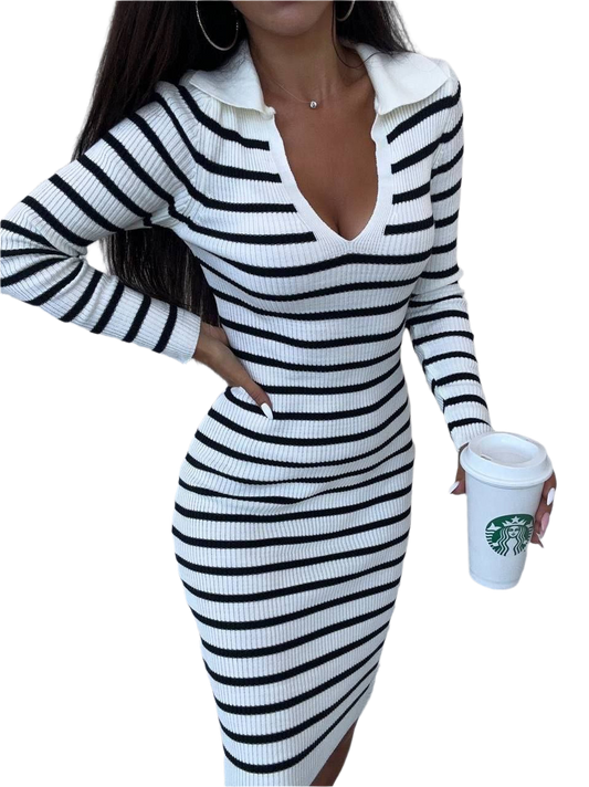Person wearing a black and white striped dress holding a Starbucks cup on a white background