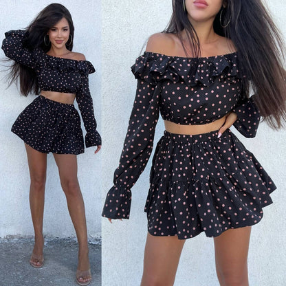 Woman wearing a black polka dot outfit with ruffled sleeves and skirt against a white background.