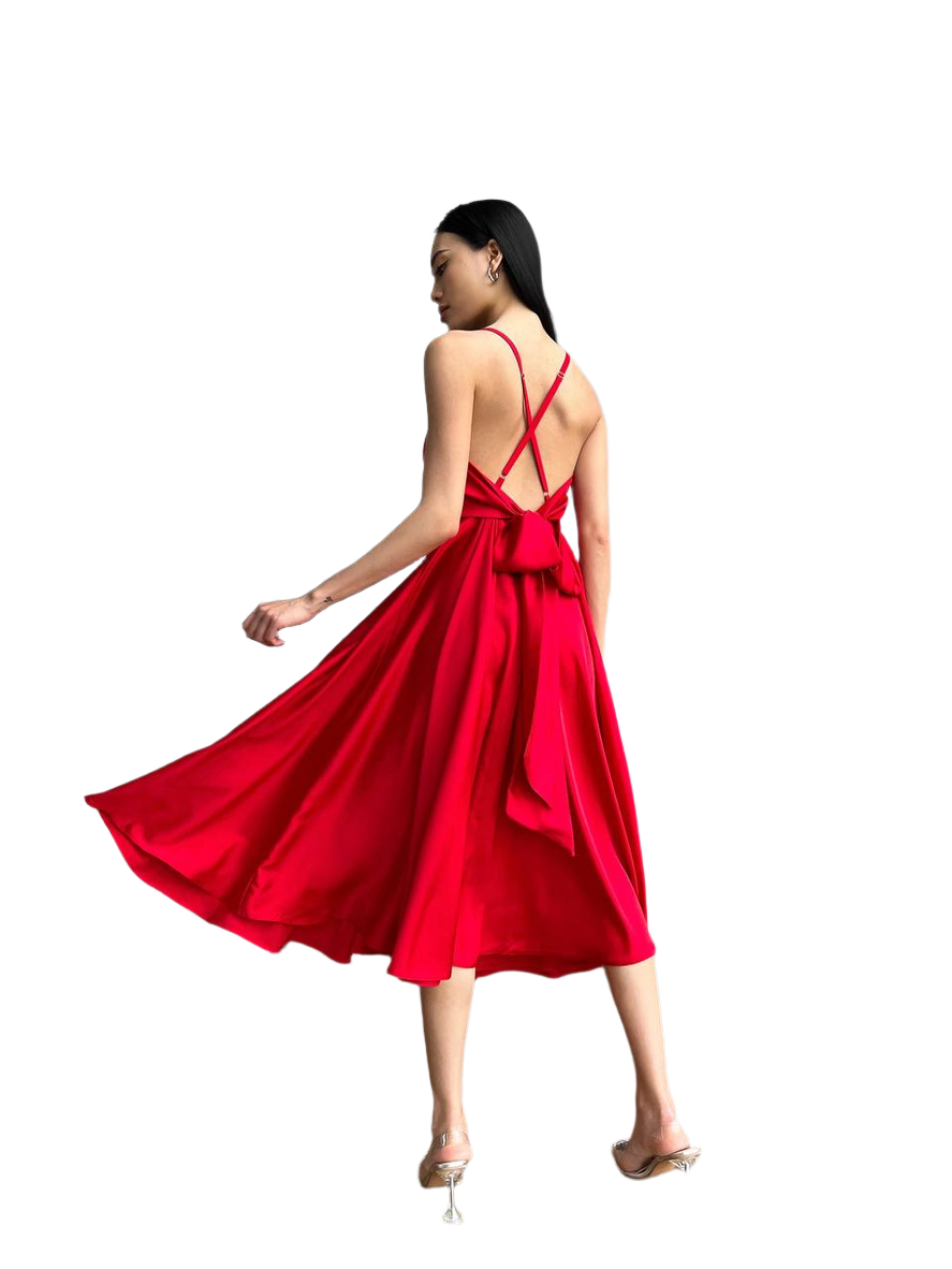 Woman wearing a red dress with thin straps on a white background