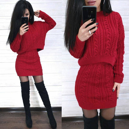 Person wearing a red cable knit sweater dress with black knee-high boots, taking a mirror selfie.
