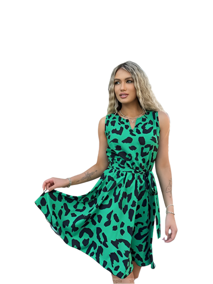 Woman wearing a green dress with black leopard print on a white background